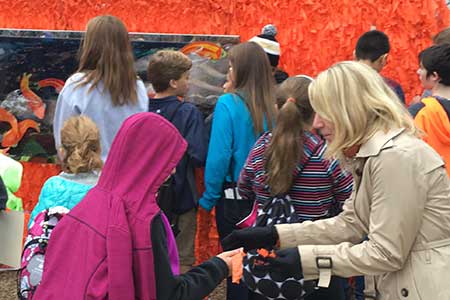 Another one of the 100,000 ribbons about to be tied on the Color Me Orange&mdash;Color Me Kind installation