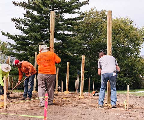 Workers installing posts during construction of the Memorial Garden