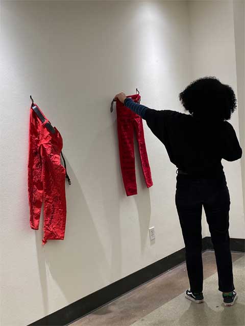 Students interact with the Red Jeans Redemption exhibit at Azusa Pacific University in Azusa, California.