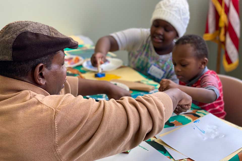 Veterans and families during workshops creating art for Yellow Ribbon installation